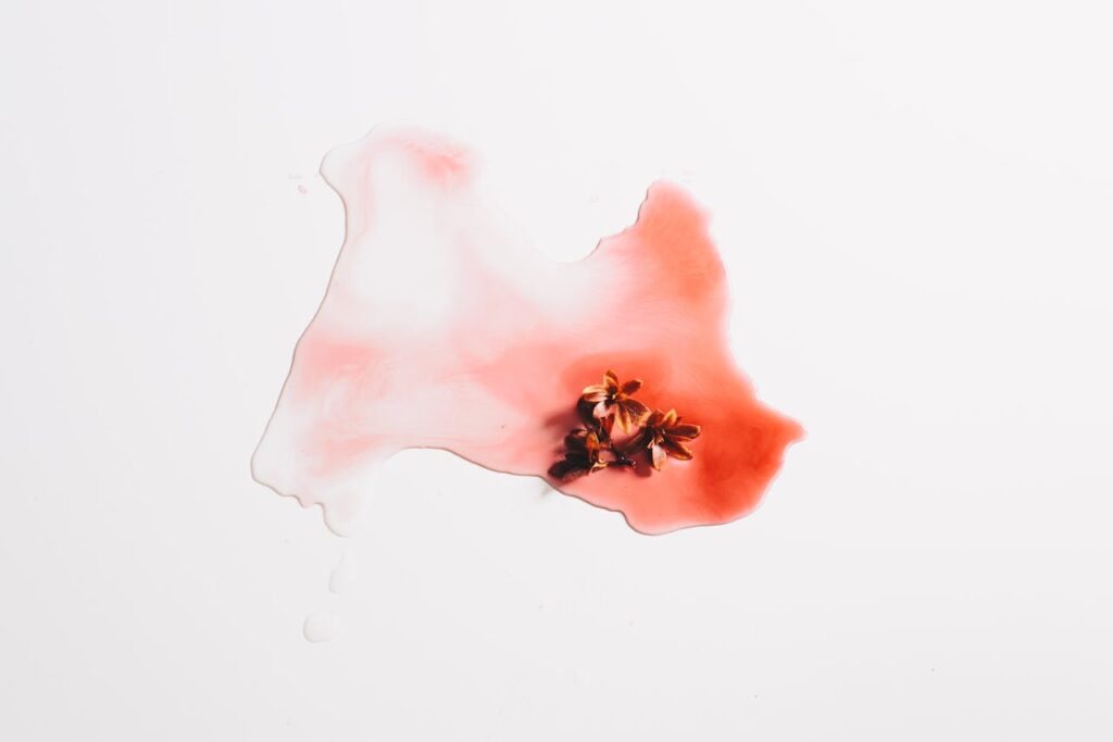 The Art of Drawing Readers In: Your attractive post title goes here Minimalistic abstract art featuring red watercolor with flower petals on a white background.